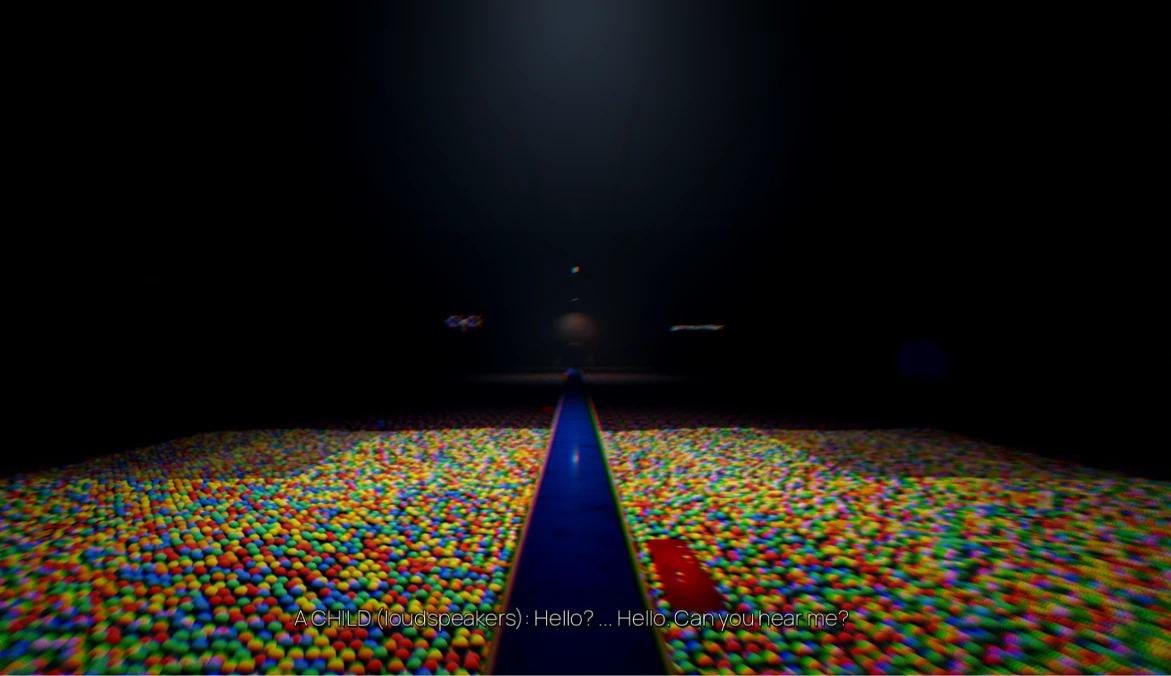 A narrow walkway across a sea of coloured balls, in the dark.